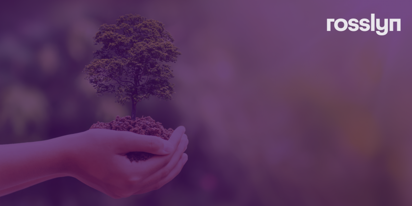 Hands holding a small tree with purple colour overlay and white logo